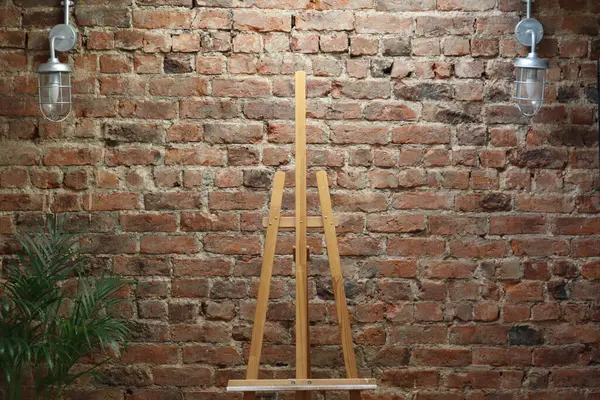 Bu iç düzenek, dokulu kırmızı tuğla bir duvara karşı ahşap bir sehpa içeriyor. İç tasarım ilhamı, sanat temalı projeler veya arkaplan olarak ideal.