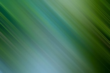 Bu çarpıcı görüntü dinamik bir hareket bulanık efekti sergiliyor, yeşil ve mavinin gölgelerini karıştırarak görsel olarak büyüleyici ve sakin soyut bir arkaplan yaratıyor.