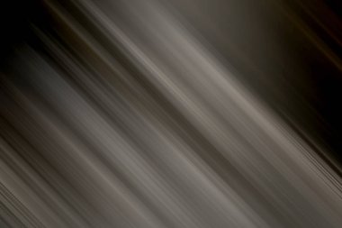 Koyu gri ve siyah renkli sofistike ve soyut bir arkaplan, bulanık köşegen çizgileri ve ince, karamsar bir gradyan, dramatik ve modern tasarım uygulamaları için mükemmel..