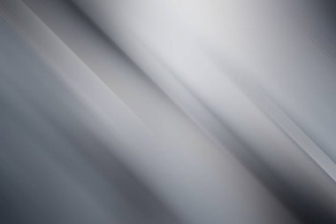 This sleek abstract background features a gradient of gray and white tones with diagonal lines, creating a modern and minimalist aesthetic for various design applications.