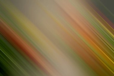 Çapraz çizgi ve hareket bulanıklığı olan soyut bir arkaplan, yeşil, turuncu ve kırmızı olmak üzere ılık sonbahar renklerinin karışımını sergiliyor, dinamik bir hareket ve derinlik hissi uyandırıyor..