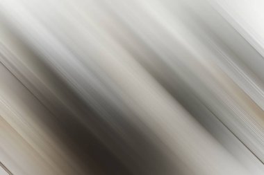 Yumuşak gri ve beyaz renklerde çapraz hareket bulanıklığı olan minimalist soyut bir arka plan, sakinlik, zarafet ve temiz tasarım hissi veriyor. Sofistike projeler için uygun.