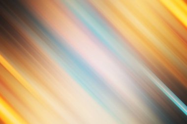 Sıcak turuncu, sarı ve mavi tonlarda köşegen ışık çizgileri içeren soyut bir arka plan, dinamik ve enerjik bir hareket bulanıklığı etkisi yaratır..