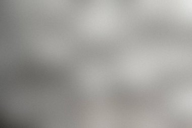 Gri ve gümüş tonlarında sofistike, soyut bir arka plan, ince taneli bir dokuya ve modern, zarif bir görünüş için hafif efektlere sahip.