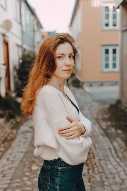 portrait of Attractive woman in sweater outside, young girl posing  clipart