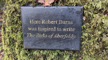 Stone monument to Robert Burns in the The Birks of Aberfeldy famous walk where Robert Burns wrote his Scottish love song in 1787. Tourist destination and natural location. clipart