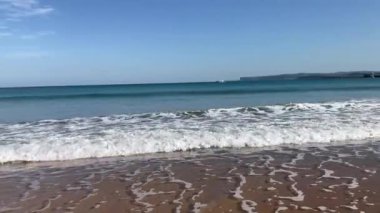 İspanya 'nın kuzey kıyısında, Santander' de El Sardinero 'nun güzel kumlu plajı. Güneşli bir günde dalgalarla okyanus manzarası