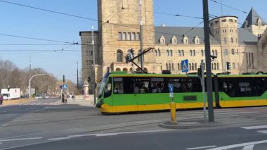 Pozna 'da sokaklarda seyahat eden bir tramvay. Poznan 'ın toplu taşıma sistemi. Polonya tramvayları. Güneşli bir günde sokak manzarası