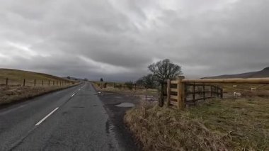 İskoç kırlarını ve tepelerini süpürdü. Perthshire sıradağları. Cnoc Beithe tepesi. Otlaklar, koyunlar ve akan su. Dağlık nehir bulutlu vahşi yerleri yakıyor.