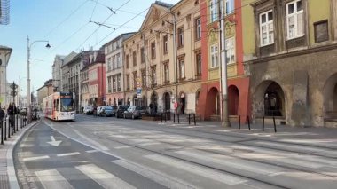 Krakow sokaklarında seyahat eden modern Polonya tramvayları. Polonya 'nın Krakw kentinin şehir manzarası. Polonya, ünlü sokak binaları yerleştirdi