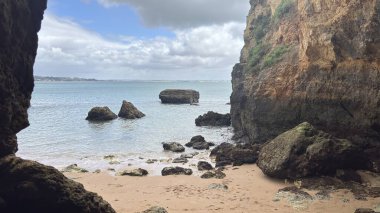Lagos yakınlarındaki Portekiz 'in Algarve sahil şeridinde güzel sahil kayalıkları, kayalar ve plajlar. Okyanus dalgaları kumtaşı yapıları turistik eğlence mağaraları geziler kumsal hayatı kumları.