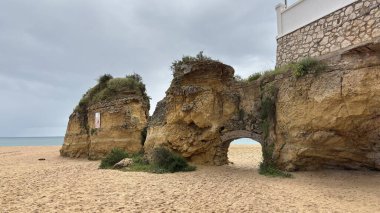 Lagos yakınlarındaki çarpıcı Algarve kıyı şeridi dramatik uçurumlar, altın plajlar, turkuaz sular ve parlak bir gökyüzü altında manzaralı okyanus manzarası.
