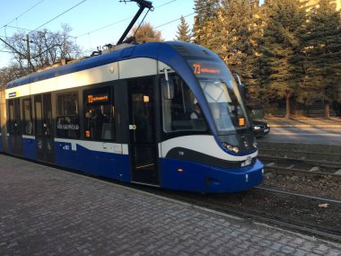 Klasik bir Krakw tramvayı, klasik toplu taşıma ve ortaçağ cazibesinin karışımını vurgulayarak tarihi caddelerde ilerliyor.
