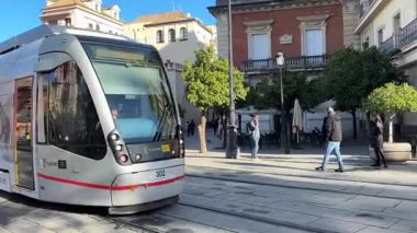 İspanya: Seville 'in MetroCentro hattında çalışan tramvaylar, tarihi şehir merkezinde geziniyor, kentsel hareketlilik ve mimari simgeler sergiliyor.