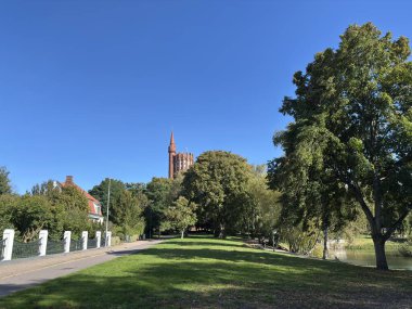 Exterior of Gamla Vattentornet the old 66-meter water tower in Landskrona Sweden designed by Fredrik Sundbarg in 1904 featuring brick construction and reservoir tank now residential building overlooking urban landscape.