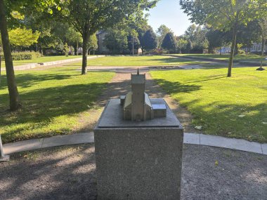 Remains of Gamla kyrkans grund former Saint John the Baptist church in Landskrona Sweden town park featuring exposed stone bases brick remnants and central wooden cross for summer services.