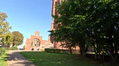 Gamla Vattentornet 1904 water tower exterior in Landskrona Sweden featuring cylindrical brick structure and reservoir tank now residential building with Oresund sea views.