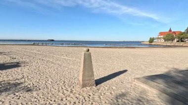 Scenic Landskrona Sweden coastline featuring Oresund waters sandy and pebbled beaches grassy dunes and Ven island horizon in natural port setting with ferry routes visible.