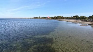 Scenic Landskrona Sweden coastline featuring Oresund waters sandy and pebbled beaches grassy dunes and Ven island horizon in natural port setting with ferry routes visible.
