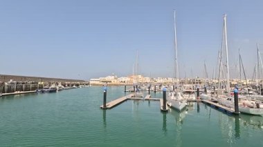 Bay of Cadiz catamaran ferry service in Spain connecting Cadiz port to El Puerto de Santa Maria and Rota featuring onboard deck perspectives harbor skyline and expansive Atlantic sea passages.