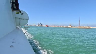 Bay of Cadiz catamaran ferry service in Spain connecting Cadiz port to El Puerto de Santa Maria and Rota featuring onboard deck perspectives harbor skyline and expansive Atlantic sea passages.