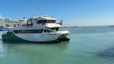 Bay of Cadiz catamaran ferry service in Spain connecting Cadiz port to El Puerto de Santa Maria and Rota featuring onboard deck perspectives harbor skyline and expansive Atlantic sea passages.