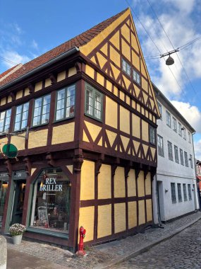 Views of Helsingr Denmark city centre architecture such as half-timbered houses on Stengade and dock scenes at Helsingr Havn with ferries to Sweden and maritime structures in resund setting.