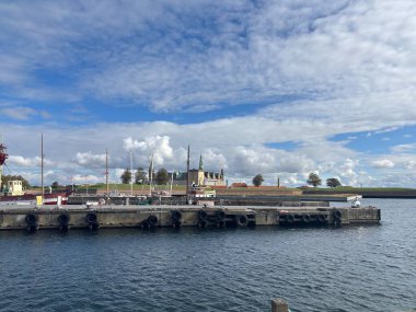 Views of Helsingr Denmark city centre architecture such as half-timbered houses on Stengade and dock scenes at Helsingr Havn with ferries to Sweden and maritime structures in resund setting.
