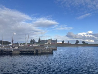 Views of Helsingr Denmark city centre architecture such as half-timbered houses on Stengade and dock scenes at Helsingr Havn with ferries to Sweden and maritime structures in resund setting.