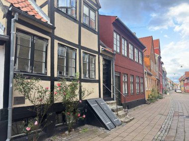 Views of Helsingr Denmark city centre architecture such as half-timbered houses on Stengade and dock scenes at Helsingr Havn with ferries to Sweden and maritime structures in resund setting.