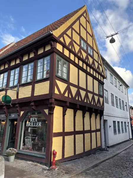 Views of Helsingr Denmark city centre architecture such as half-timbered houses on Stengade and dock scenes at Helsingr Havn with ferries to Sweden and maritime structures in resund setting.