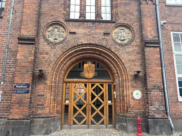 Views of Helsingr Denmark city centre architecture such as half-timbered houses on Stengade and dock scenes at Helsingr Havn with ferries to Sweden and maritime structures in resund setting.