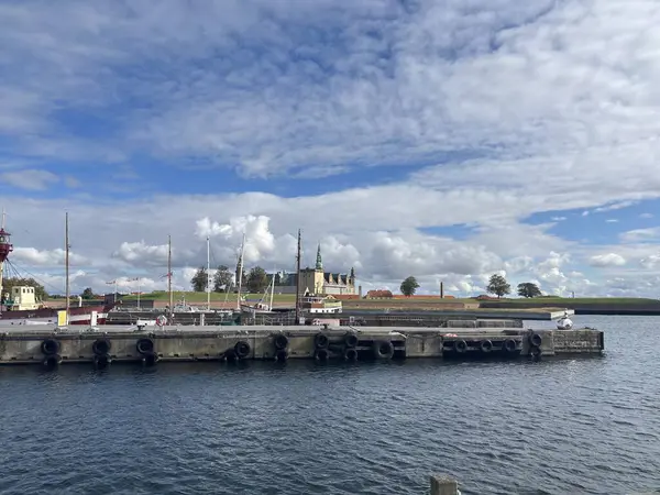 Views of Helsingr Denmark city centre architecture such as half-timbered houses on Stengade and dock scenes at Helsingr Havn with ferries to Sweden and maritime structures in resund setting.