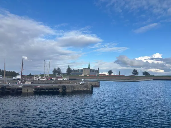 Views of Helsingr Denmark city centre architecture such as half-timbered houses on Stengade and dock scenes at Helsingr Havn with ferries to Sweden and maritime structures in resund setting.