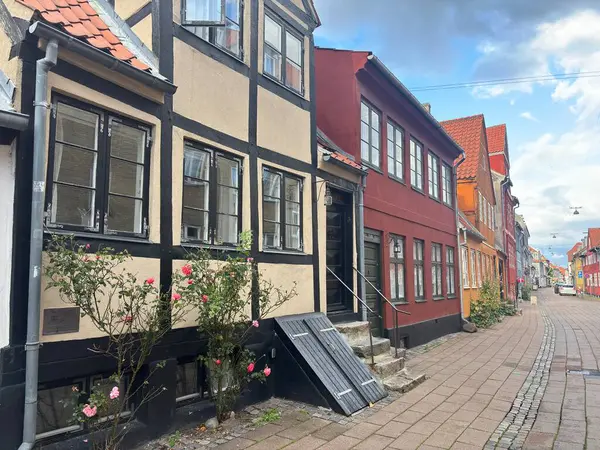 Views of Helsingr Denmark city centre architecture such as half-timbered houses on Stengade and dock scenes at Helsingr Havn with ferries to Sweden and maritime structures in resund setting.