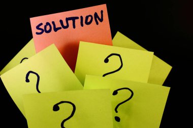 on a black background, yellow sticky notes with question marks, among them one orange note with the word solution. clipart