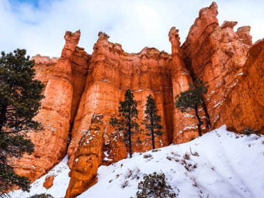 Snow scene colorful cliffs with  red rock and stone in Bryce Canyon National Park clipart