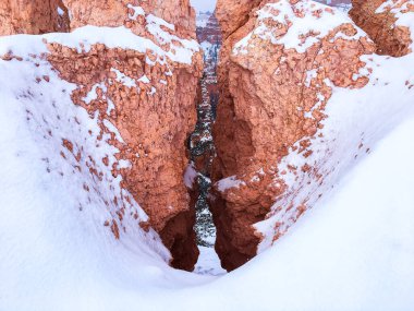 Snow scene colorful cliffs with  red rock and stone in Bryce Canyon National Park clipart