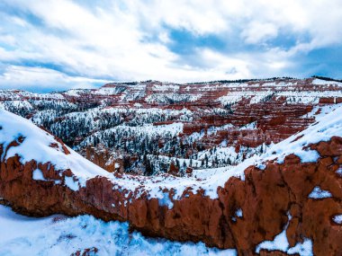 Bryce Canyon Ulusal Parkı 'nda kırmızı kaya ve taşlı kar manzaralı uçurumlar