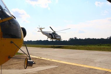 Sikorsky S-61N helicopter taking off from Urucu airport for operation in the Amazon jungle clipart