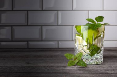 Resmin sağ tarafında duran orijinal Caipirinha kokteyli. Metin için boş alan. Nane, rom, limon, şeker ve buzlu lezzetli bir kokteyl..