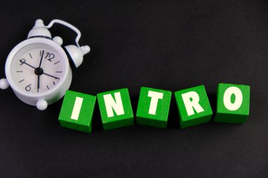 Eğitim olarak INTRO metni ve koyu arkaplan üzerine sunum konsepti içeren yeşil renkli tahta bloklar.