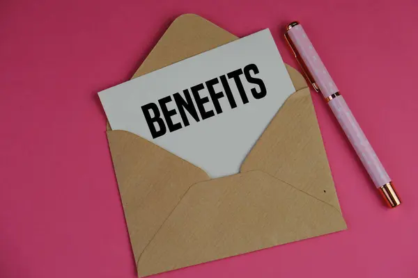 Laptopun yanındaki kahverengi zarfın içindeki düz kartta BENEFITS 'in metni. iş kavramı. 