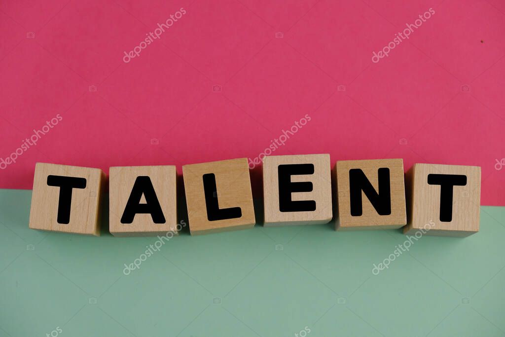 TALENTS words from wooden blocks with letters, ethics moral philosophy concept, pink and green background