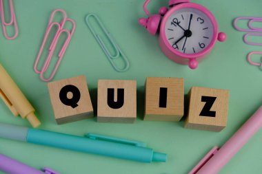 the words Its Quiz on color wooden blocks. the concept of answering quizzes or quiz games clipart