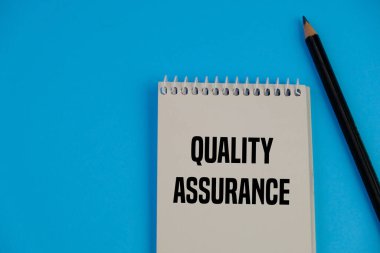 İş konsepti - Üst görünüm not defteri yazma Kalite Güvencesi