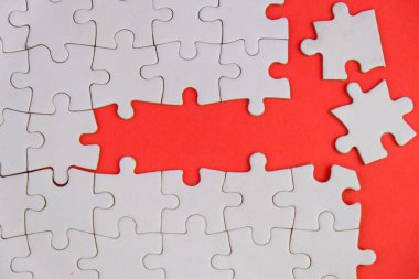 Metin şablonu için eksik parçaları olan boş beyaz bulmaca. Yeşil arkaplanda izole edilmiş fotoğrafın üzerinde