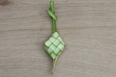 Tahta bir masada ketupat veya pirinç keki. Kurban Bayramı 'nda geleneksel Endonezya yemekleri