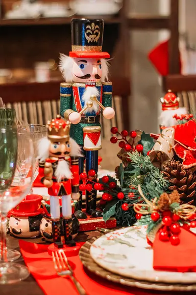 stock image Wooden nutcracker adorns a table, blending seamlessly with festive Christmas decorations for a cozy holiday touch