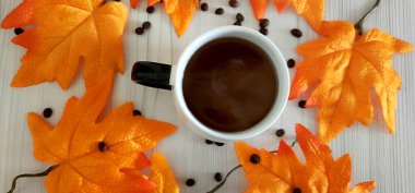 Masada sonbahar yaprakları olan bir fincan kahve. Yüksek kalite fotoğraf